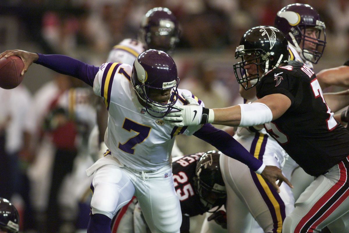 The Vikings beat the Atlanta Falcons in the season opener in Atlanta Sunday. -- Falcons tackle Shane Dronett puts pressure on Vikings quarterback Randall Cunningham, who still managed to toss the ball off successfully during this play in the first quarter