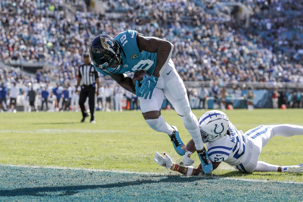 Wide Receiver Laquon Treadwell #18 of the Jacksonville Jaguars scores a touchdown against defensive back Kenny Moore II #23 of the Indianapolis Colts at TIAA Bank Field on January 9, 2022 in Jacksonville, Florida.
