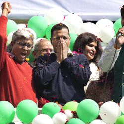 In this Tuesday, Feb. 10, 2015 file photo, Aam Aadmi Party, or Common Man"™s Party leader Arvind Kejriwal, center, coughs while the party's senior leader Ashutosh, left, and others shout slogans to celebrate the party's election performance in New Delhi, India. Kejriwal, the former tax official with the chronic cough and the ill-fitting sweaters, the man who had remade himself into a champion for clean government, seemed lost in the political wilderness. The crusading politician was suddenly a punchline. But on Wednesday, Feb. 11, there was Kejriwal on the front page of nearly every Indian newspaper, celebrating election results that again make him New Delhi's chief minister. Kejriwal and the party he created routed the country's best-funded and best-organized political machine and dealt an embarrassing blow to Prime Minister Narendra Modi.