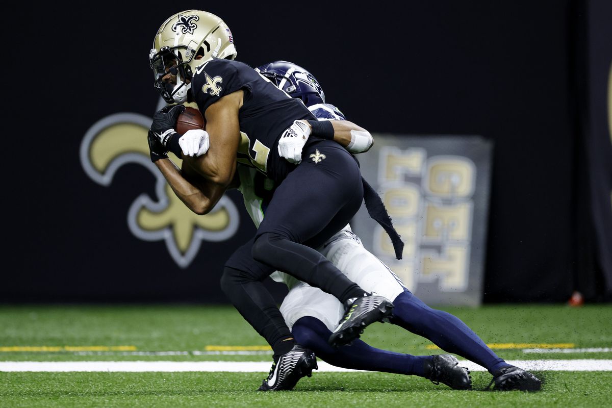 Chris Olave #12 of the New Orleans Saints catches the ball for a touchdown during the third quarter against the Seattle Seahawks at Caesars Superdome on October 09, 2022 in New Orleans, Louisiana.