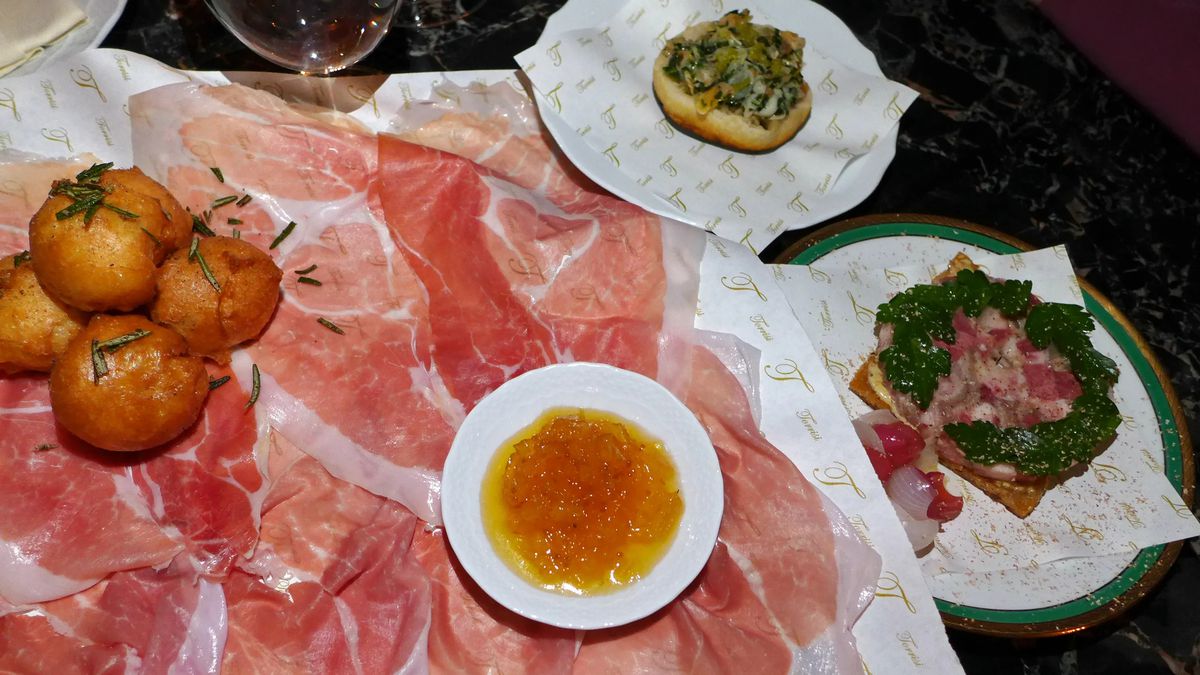 Ham and other small plates on a table.