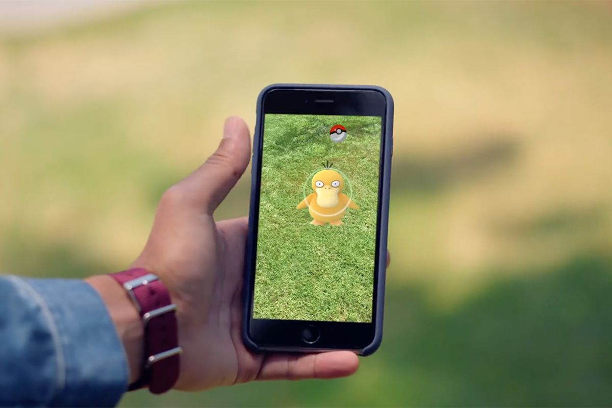 A player catches a Psyduck using AR mode in Pokémon Go