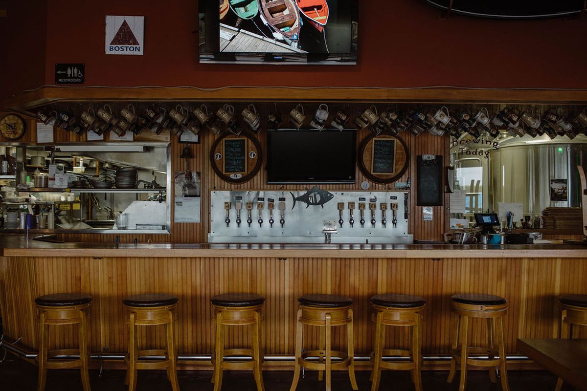 An empty bar decorated with Boston sports memorabilia 