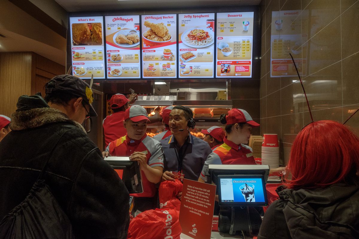 Customers stand in line at a Manhattan location Jollibee, a Filipino fast food chain.