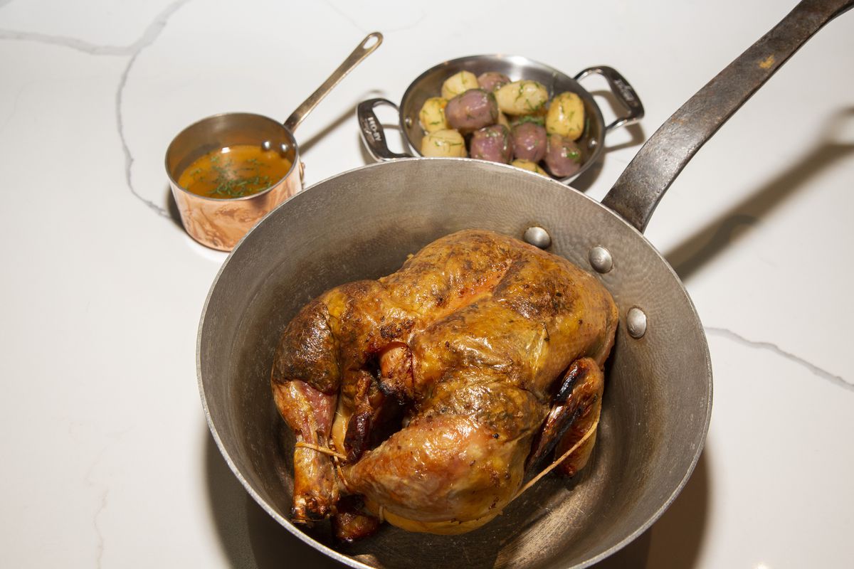 A roast chicken in a pot.