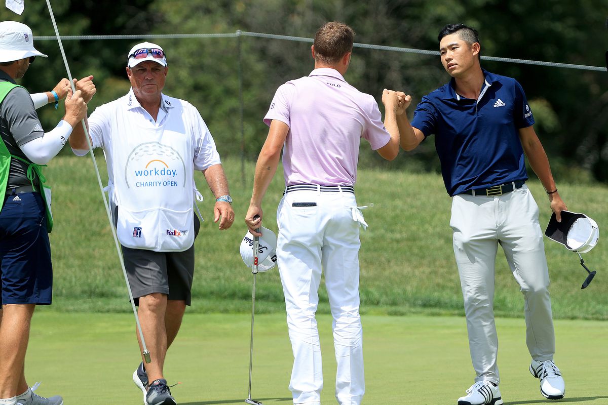 Collin Morikawa of the United States is congratulated by Justin Thomas of the United States after Morikawa defeated Thomas on the tenth green in the third playoff hole during the final round of the Workday Charity Open on July 12, 2020 at Muirfield Village Golf Club in Dublin, Ohio.