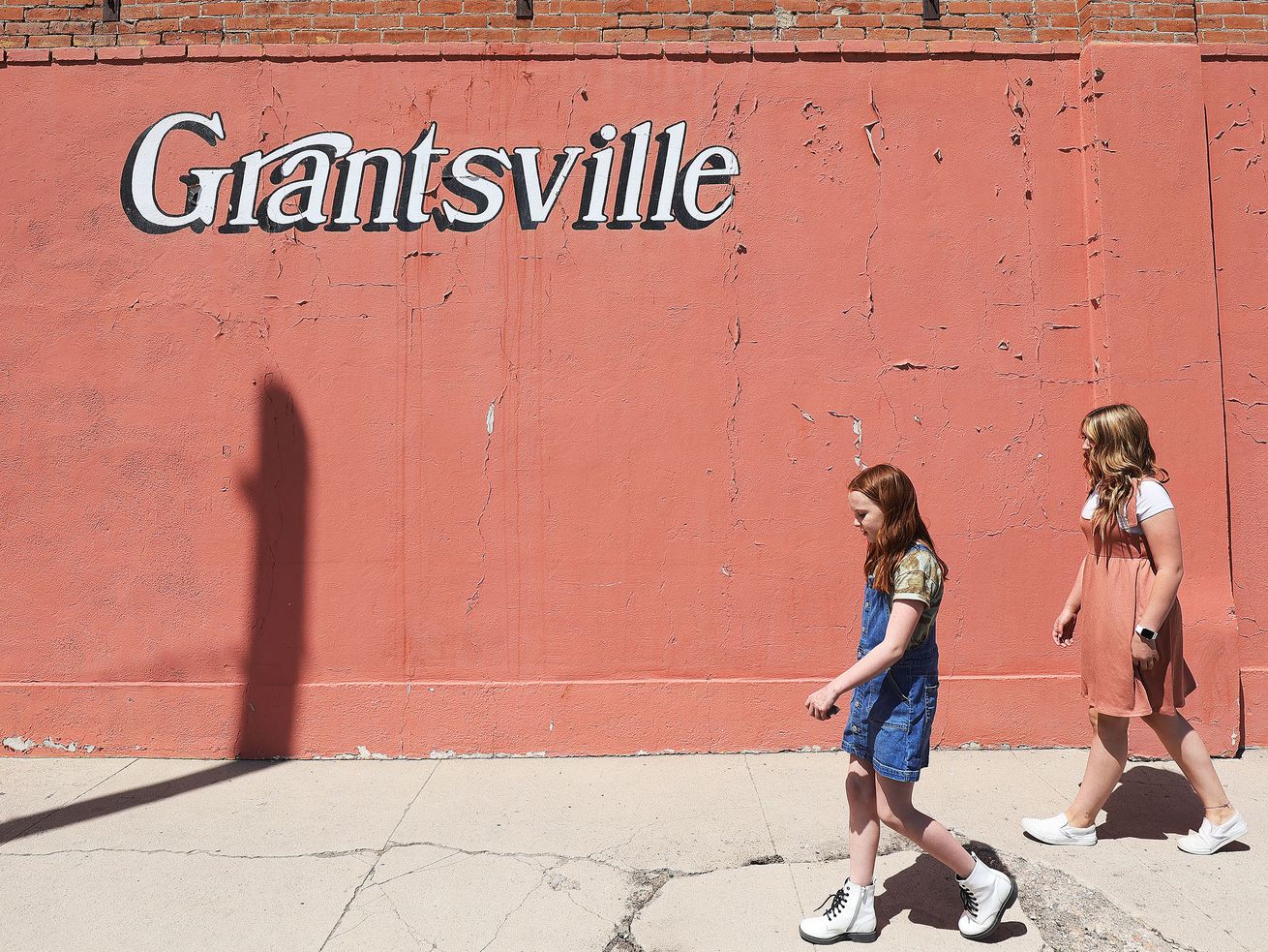 Lucie Moffitt, 10, and her sister, Lydia Moffitt, 14, walk to the ice cream store near their home in Grantsville on Friday, May 21, 2021. Their mother, Jamie Moffitt, decided to teach her children about safety and responsibility and then trust them to have a childhood.