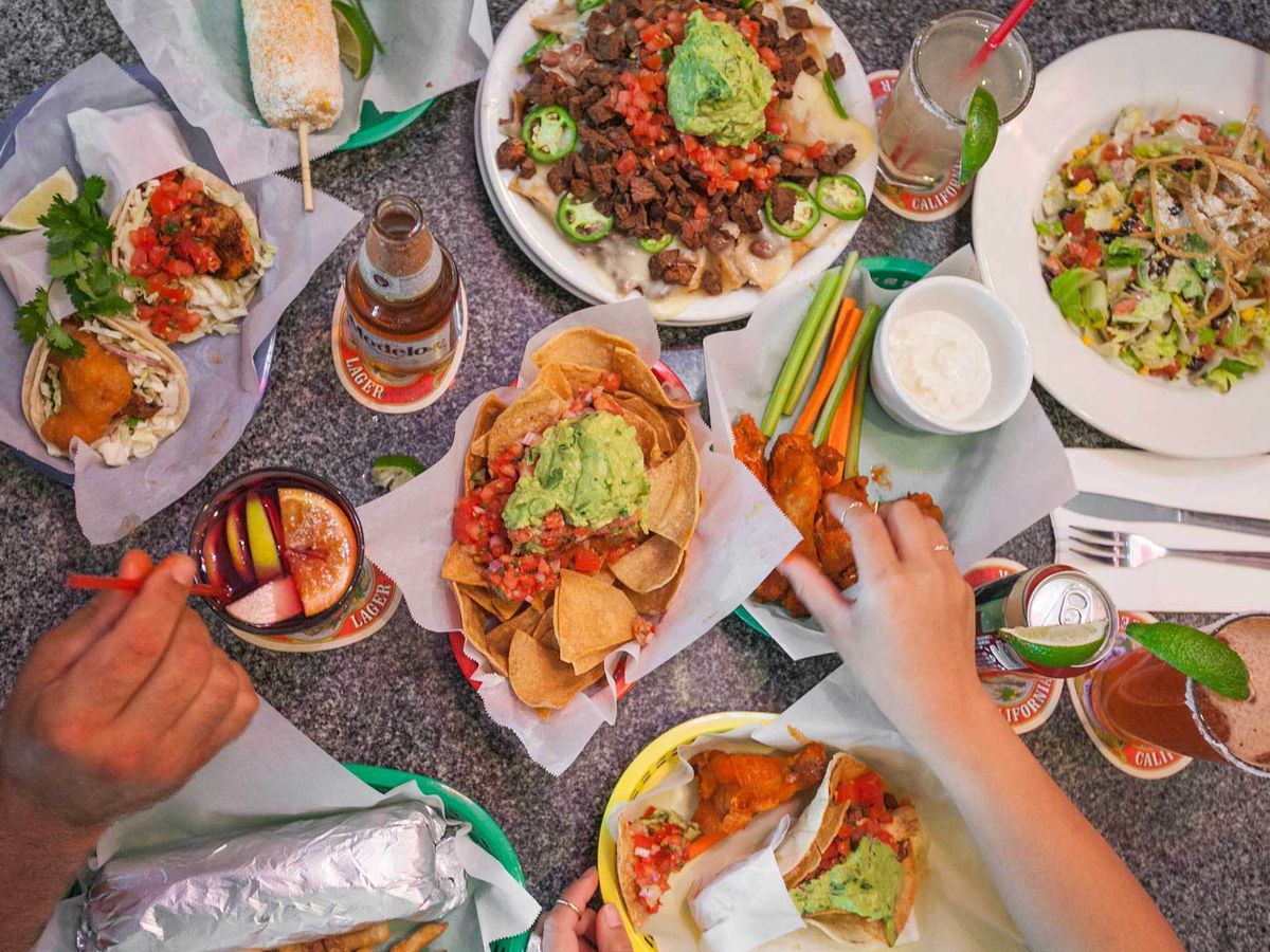 A spread of tacos and drinks from Underdogs Taco Shop.