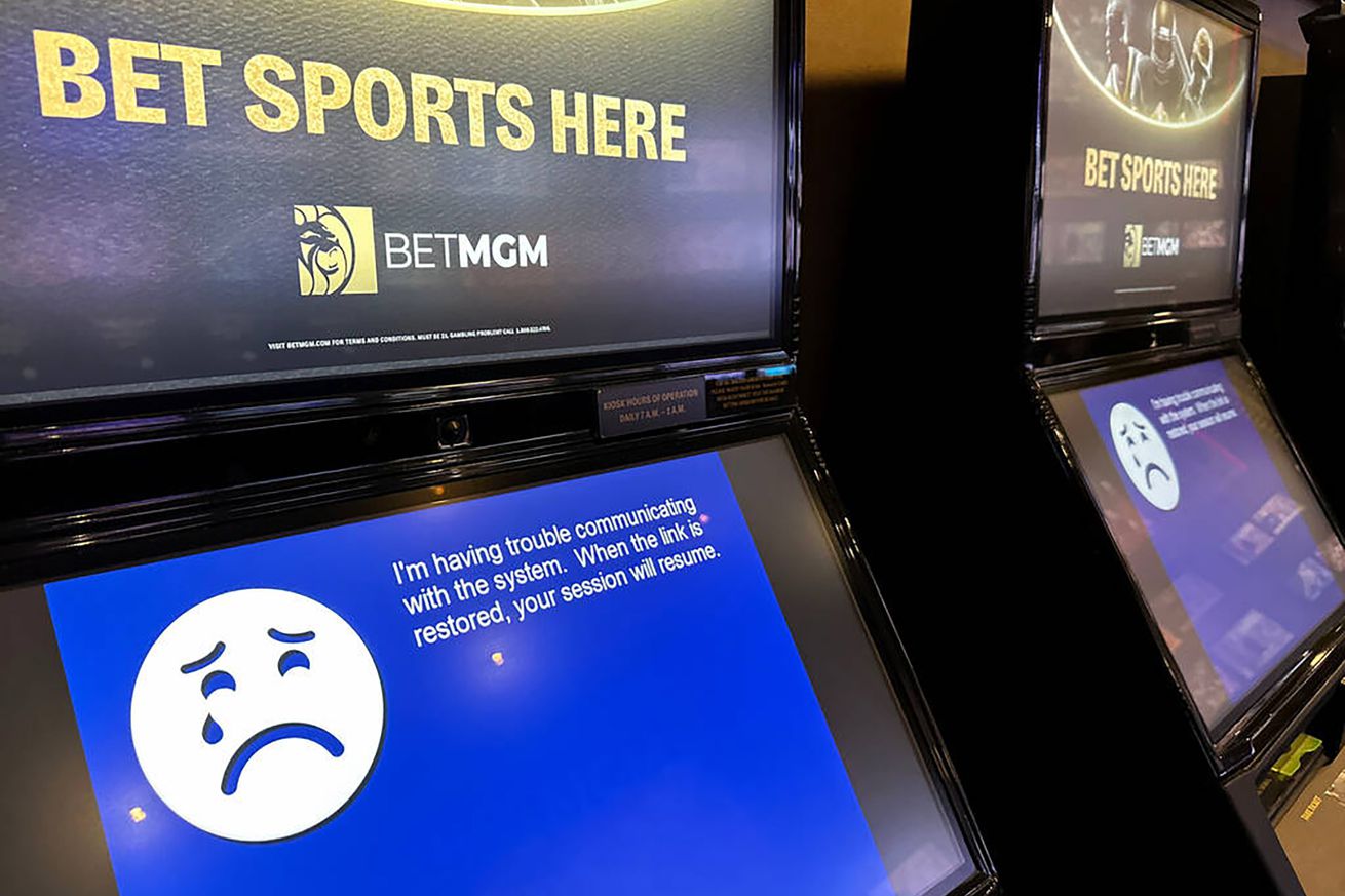A picture shows a sports betting machine with a blue screen of death featuring a cartoon face, crying and frowning next to a message saying the machine is out of order.