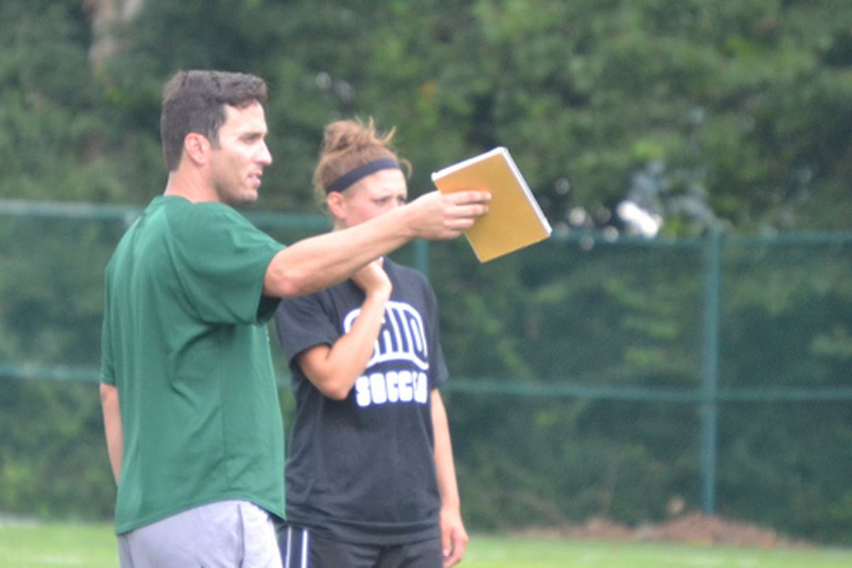 New head coach Aaron Rodgers offers some instruction during fall practice.