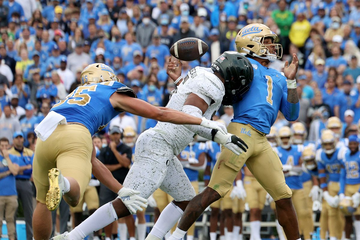 Dorian Thompson-Robinson #1 of the UCLA Bruins loses the ball as he is sacked by Kayvon Thibodeaux #5 of the Oregon Ducks in front of Greg Dulcich #85 during the second half in a 34-31 Bruins loss at Rose Bowl on October 23, 2021 in Pasadena, California.