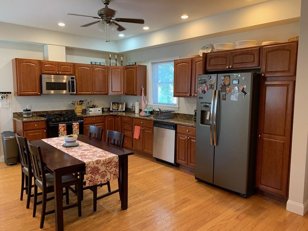 A sizable kitchen with a table and chairs.
