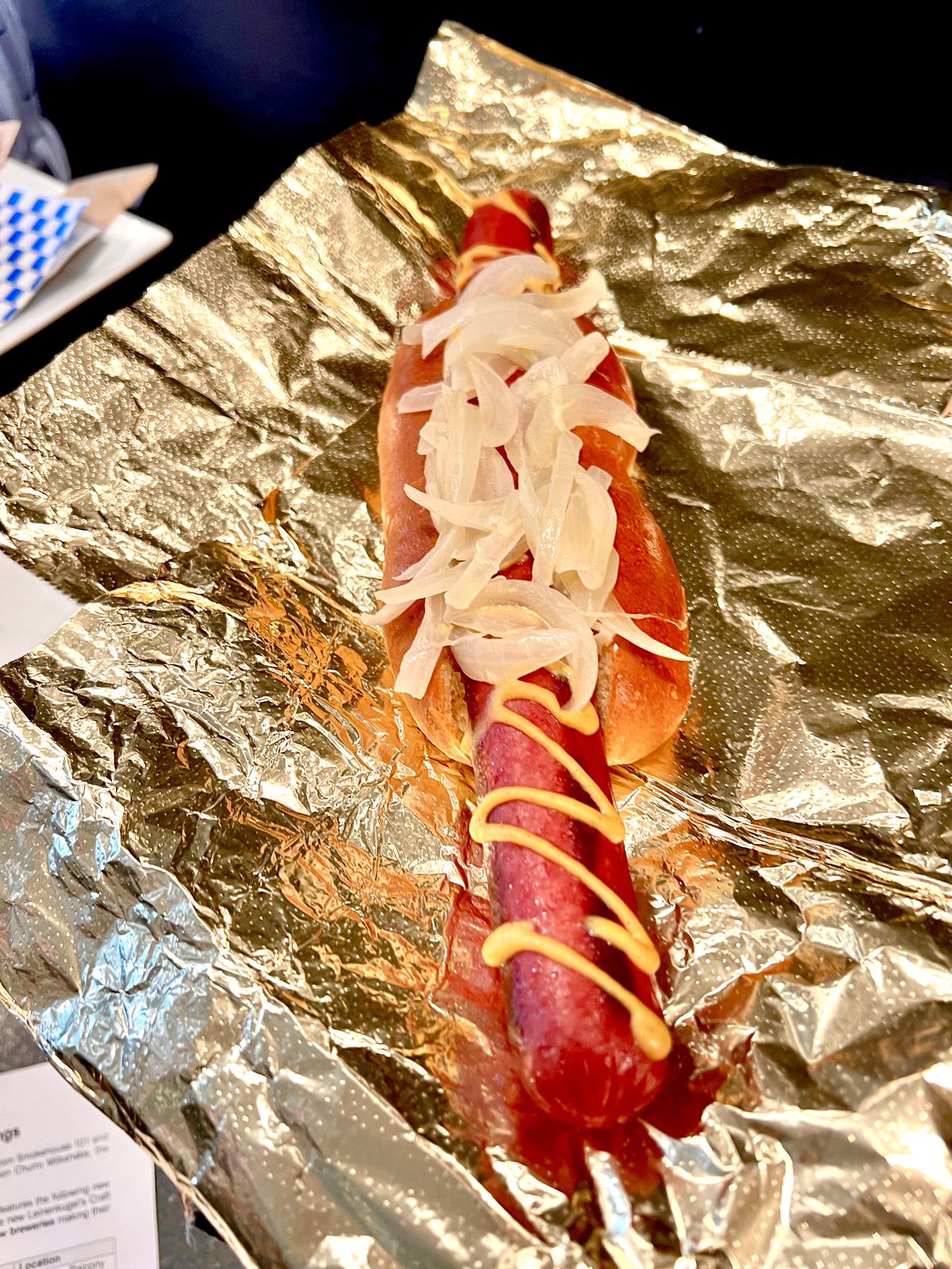 A giant hot dog with onions.