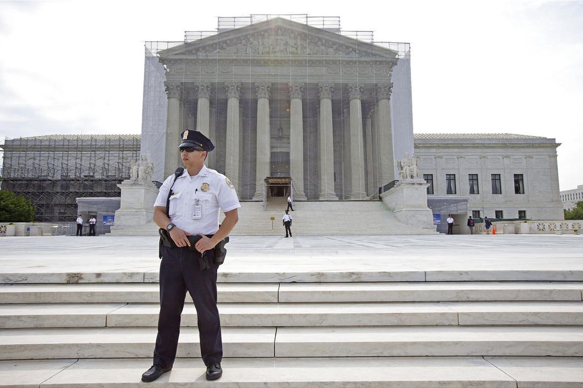 A police officer keeps watch outside the Supreme Court in Washington, Monday, June 17, 2013. With a week remaining in the current Supreme Court term, several major cases are still outstanding that could have widespread political impact on same-sex marriag
