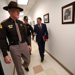 Utah Highway Patrol Col. Michael Rapich and Lt. Jeff Nigbur lead Gov. Gary Herbert on a tour of the Utah Highway Patrol's headquarters in Murray on Wednesday, Dec. 7, 2016.