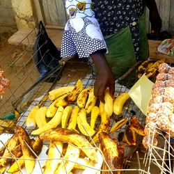 At a market near a fisherman’s wharf in Greater Accra, a woman sells grilled plantain.