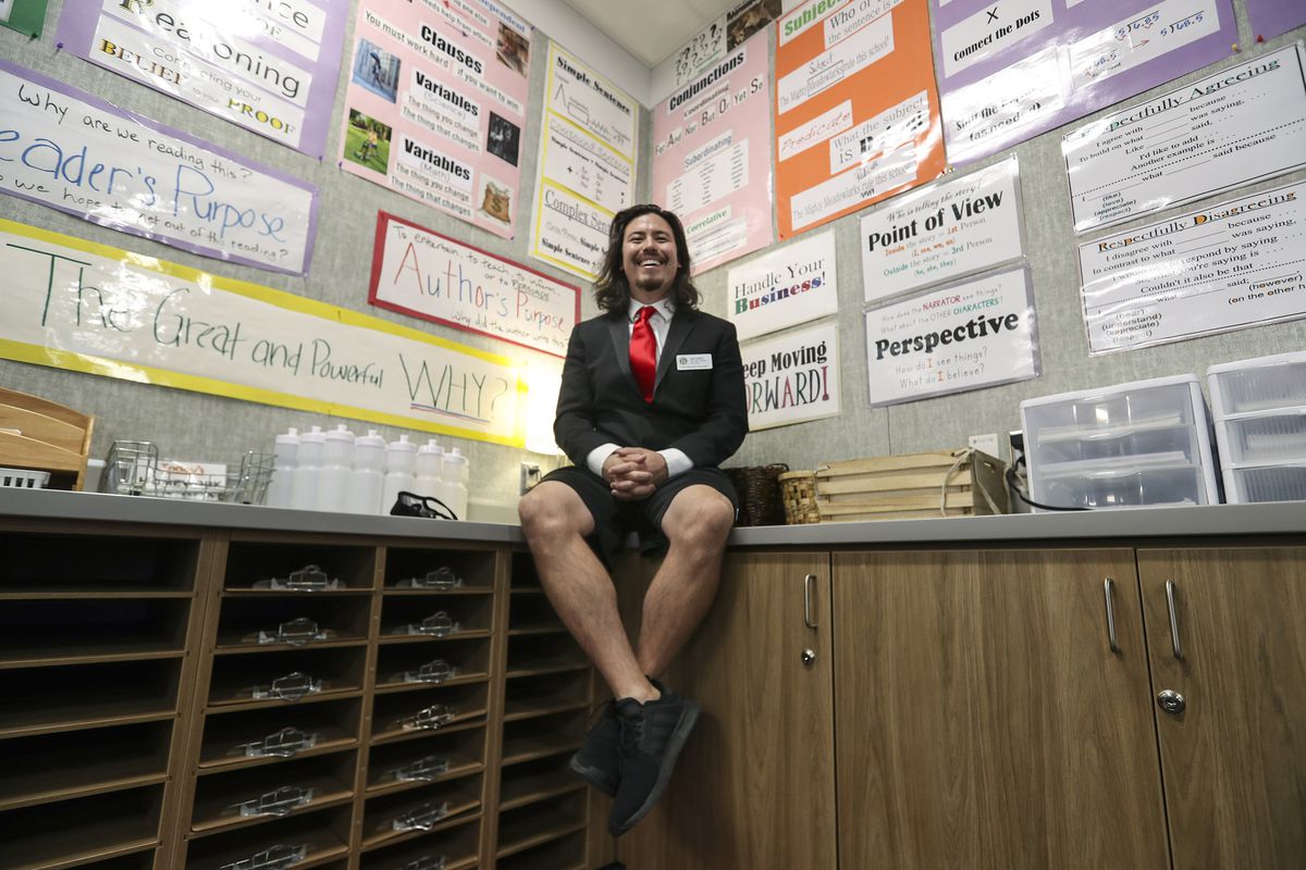 John Arthur, Utah’s Teacher of the Year, wears a special punk tuxedo jacket and gym shorts as he poses for a photo in his sixth grade classroom at Meadowlark Elementary School in Salt Lake City after learning of the award on Thursday, Oct. 1, 2020.