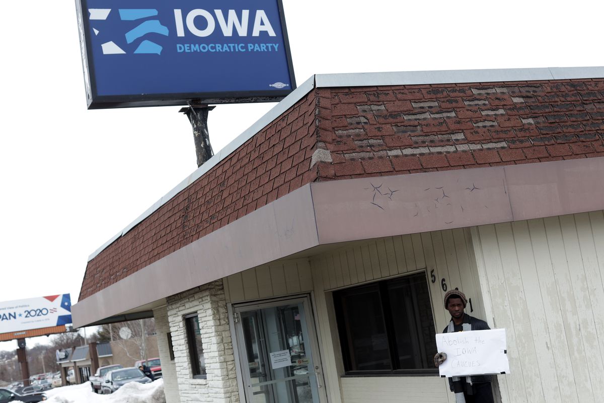 Local resident Wallace Mazon holds a sign outside the Iowa Democratic Party headquarters February 4, 2020 in Des Moines, Iowa.&nbsp;