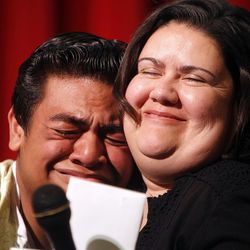 Siaosi Heimuli, left, receives a hug from his teacher, Keri Gaybill, right, at a ceremony honoring Heimuli as Granite School District's Absolutely Incredible Kid at Granite Park Jr. High in Salt Lake City on Monday, May 23, 2016.