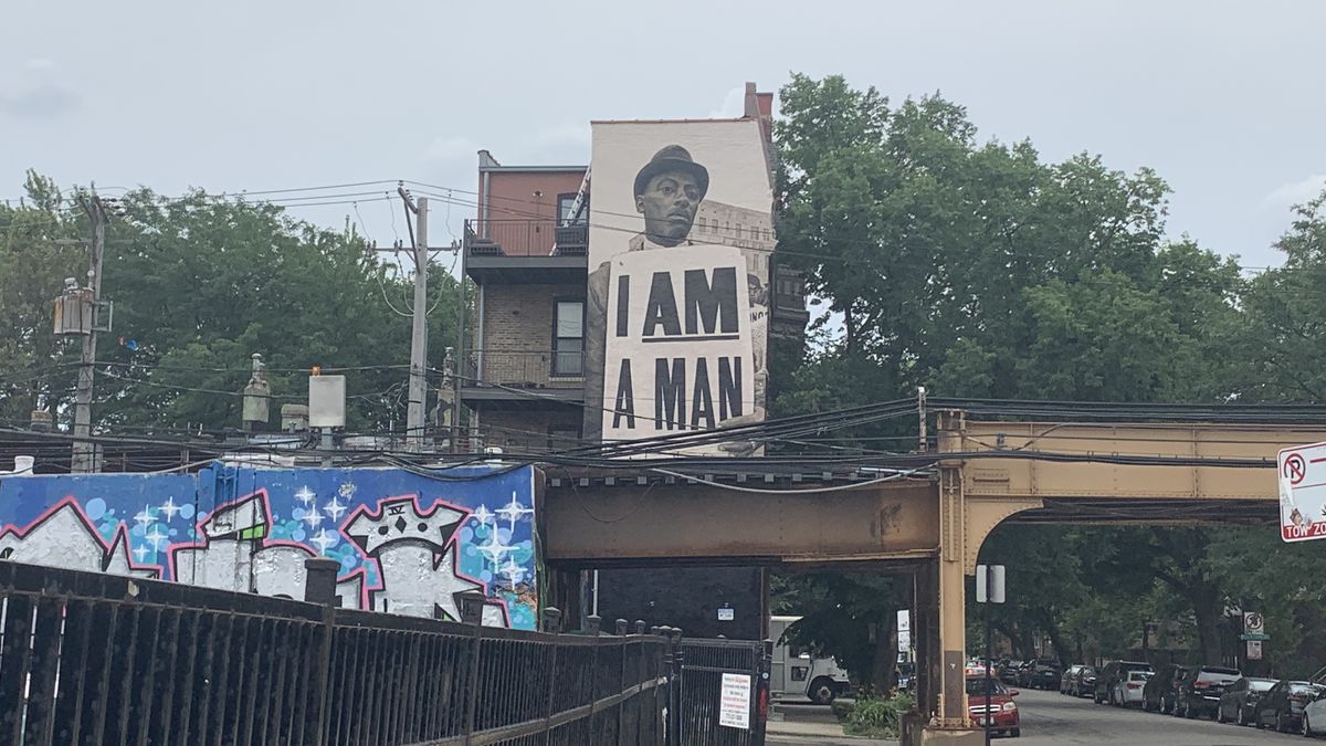 Looming above the CTA Blue Line L tracks in Wicker Park is an “I AM A MAN” mural inspired by a 1968 photograph from a Memphis memorial for the Rev. Martin Luther King Jr.