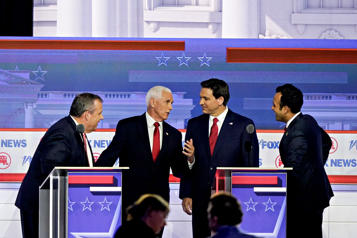 Chris Christie, Mike Pence, Ron DeSantis, and Vivek Ramaswamy chat onstage at the Republican debate on August 23, 2023.