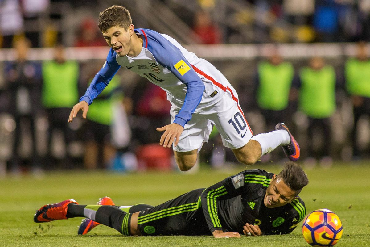 USA midfielder Christian Pulisic (10) is fouled by Mexico defender Carlos Salcido (3) during the second half of the match at MAPFRE Stadium. 