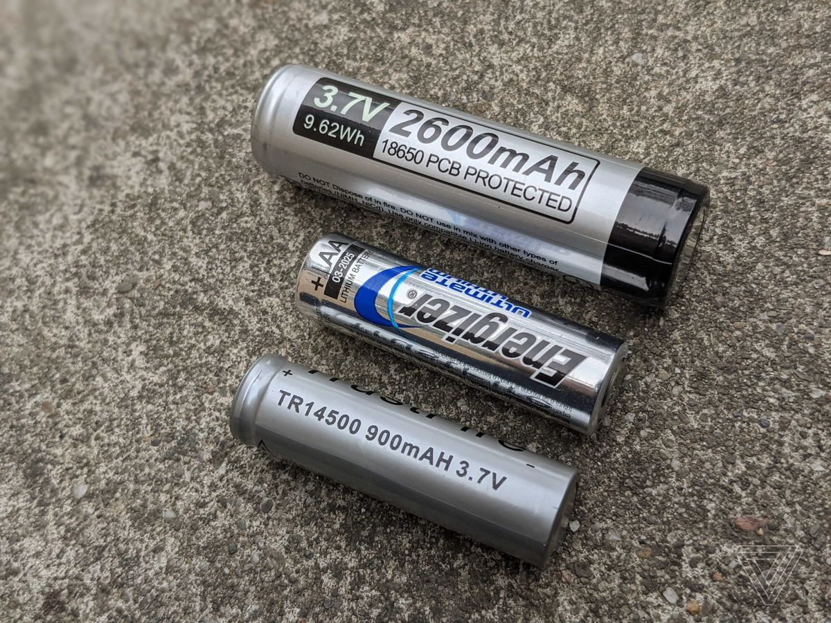 Two rechargeable Li-ion batteries, an 18650 and an 14500, next to a standard AA for scale.