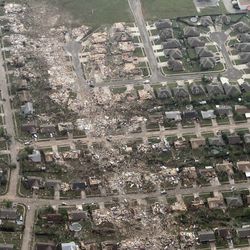This aerial photo shows the remains of homes hit by a massive tornado in Moore, Okla., Monday May 20, 2013. A tornado roared through the Oklahoma City suburbs Monday, flattening entire neighborhoods, setting buildings on fire and landing a direct blow on an elementary school.