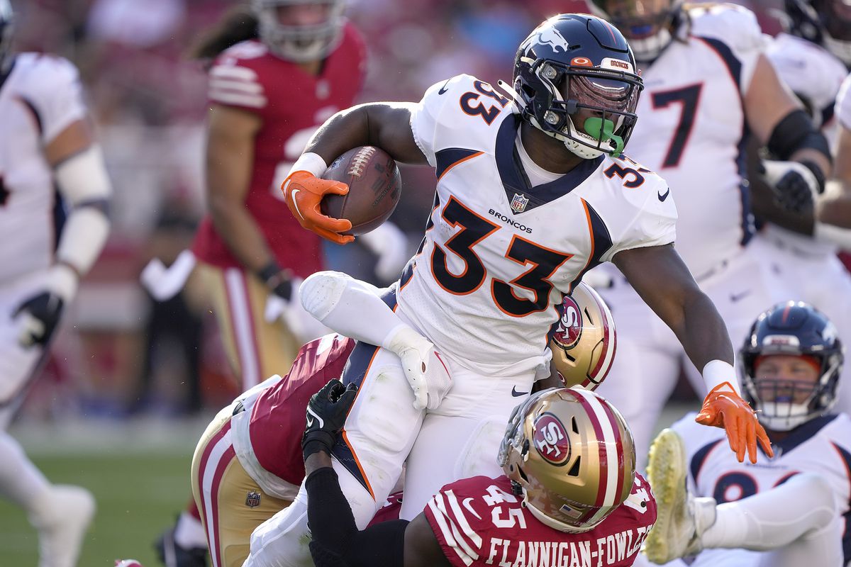 SANTA CLARA, CALIFORNIA - AUGUST 19: Javonte Williams #33 of the Denver Broncos gets tackled by Demetrius Flannigan-Fowles #45 of the San Francisco 49ers during the first quarter at Levi’s Stadium on August 19, 2023 in Santa Clara, California.  &nbsp;   
