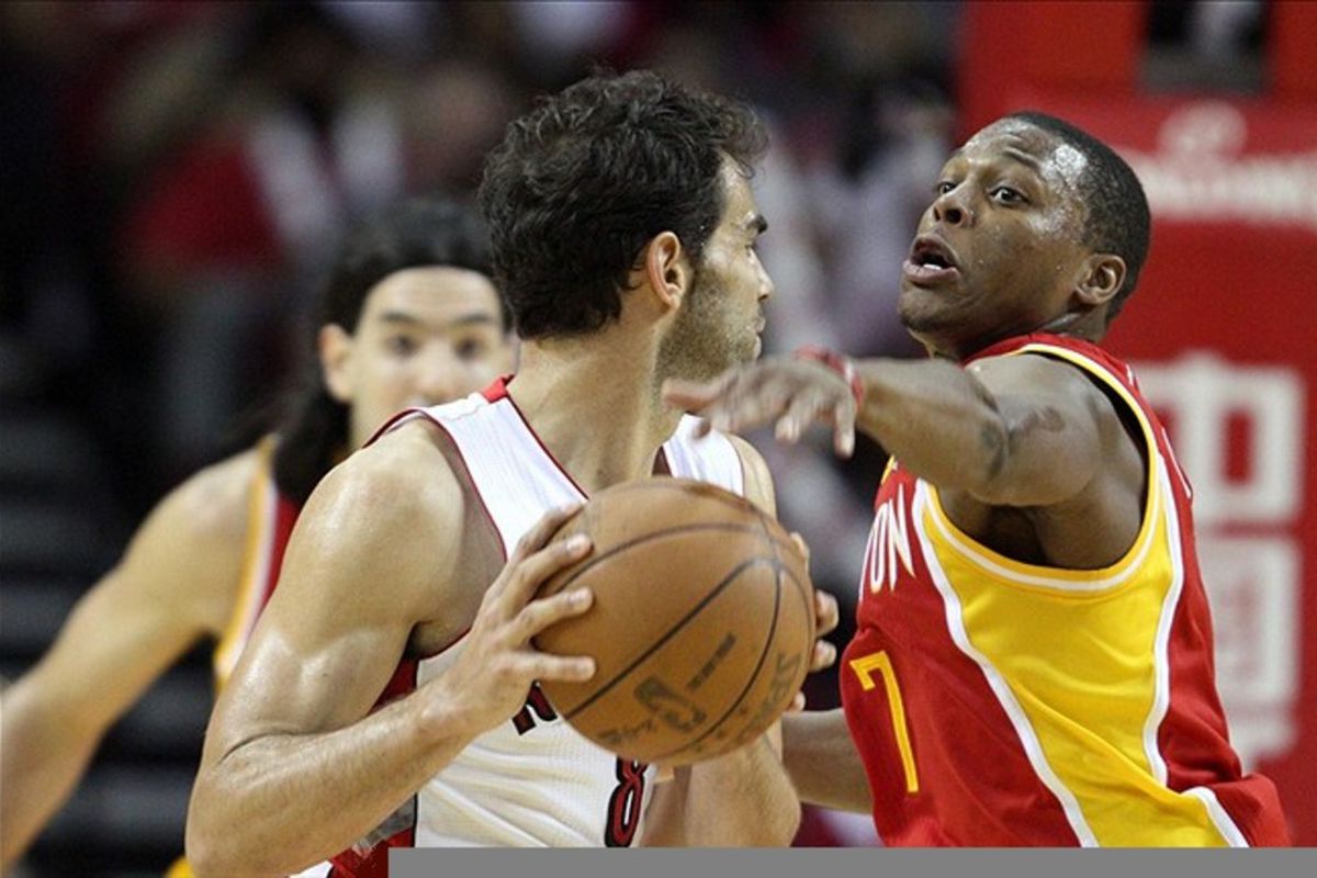 Feb 28, 2012; Houston, TX, USA; Houston Rockets point guard Kyle Lowry (7) steals the ball from Toronto Raptors point guard Jose Calderon (8) during the third quarter at the Toyota Center. Mandatory Credit: Thomas Campbell-US Presswire