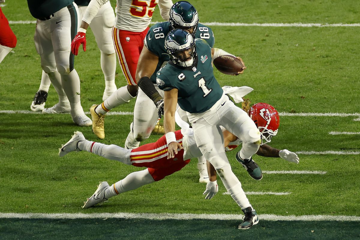 Jalen Hurts #1 of the Philadelphia Eagles runs for a 4 yard touchdown during the second quarter against Justin Reid #20 of the Kansas City Chiefs in Super Bowl LVII at State Farm Stadium on February 12, 2023 in Glendale, Arizona.