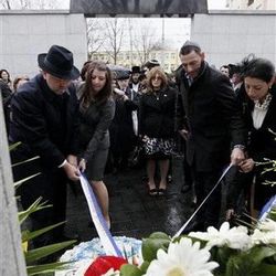 Members of the Nissenbaum foundation lay flowers at the Umschlagplatz memorial during ceremonies marking the 70th anniversary of the outbreak of the Warsaw Ghetto Uprising, in Warsaw.in Warsaw, Poland, Friday, April 19, 2013.  (AP Photo/Czarek Sokolowski)