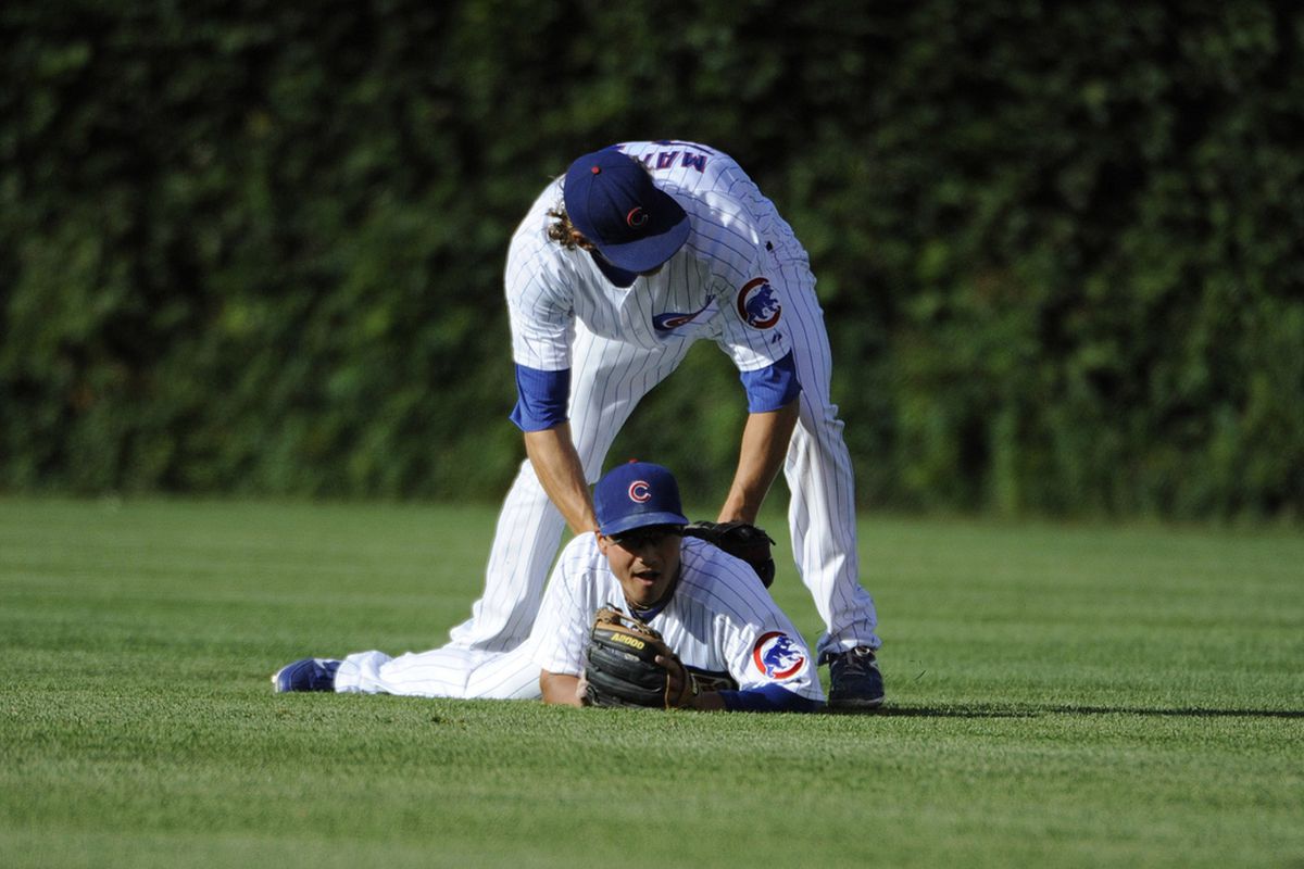 Or, write your own caption: Darwin Barney and Joe Mather of the Chicago Cubs can't make a catch against the Cincinnati Reds at Wrigley Field in Chicago, Illinois. (Photo by David Banks/Getty Images) 