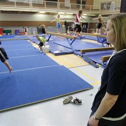 Leeann Whiffen watches Clay, her son, do gymnastics. Whiffen credits early intervention with helping her son. A study of adult Utahns with autism may offer parents hope. 