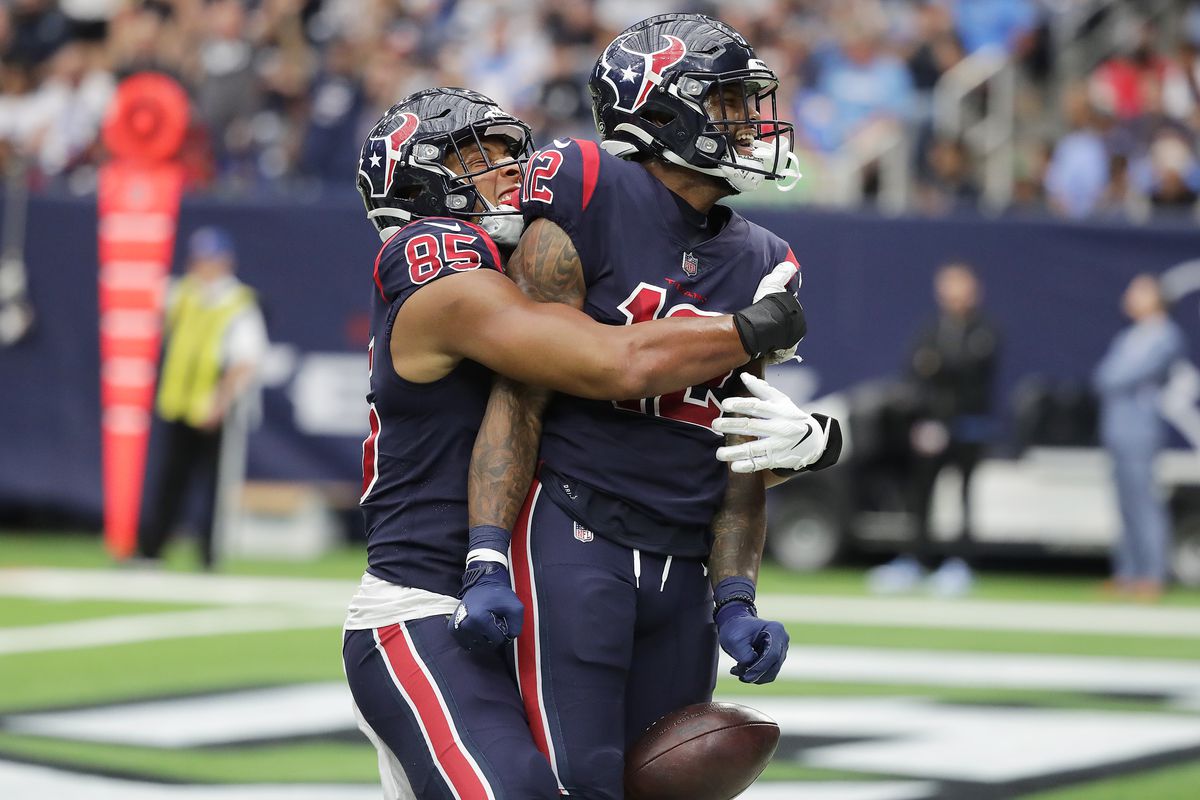 Nico Collins #12 of the Houston Texans celebrates with Pharaoh Brown #85 after catch a pass for a touchdown during the fourth quarter against the Los Angeles Chargers at NRG Stadium on December 26, 2021 in Houston, Texas.