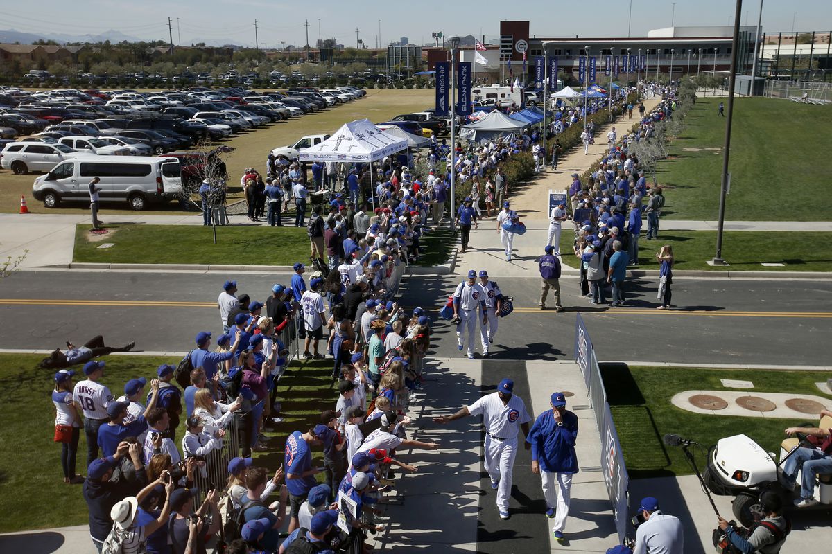 Fans line the pathway from the Chicago Cubs clubhouse as the 2016 World Series champs approach Sloan Park for their Cactus League debut against the Oakland Athletics, Saturday, Feb. 25, 2017, in Mesa, Az. (Karl Mondon/Bay Area News Group)