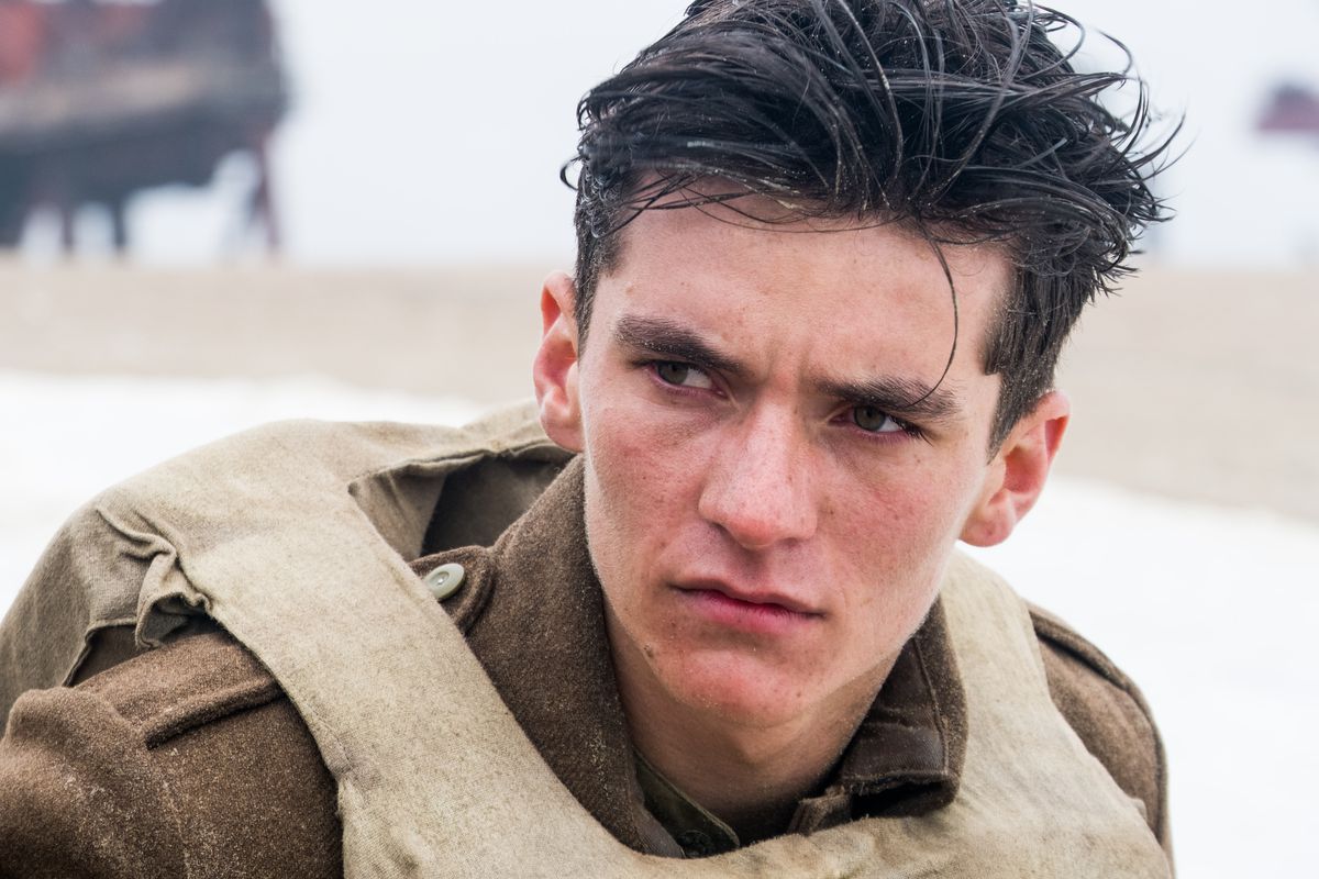 A dark-haired pale-skinned World War 2 soldier looking determined. 