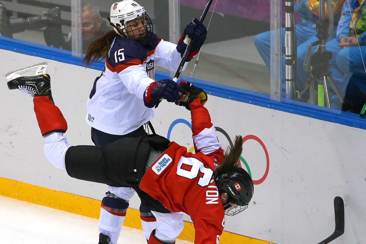 Girls don't hit, do they? USA's Anne Schleper has a friendly discussion with Canada's Rebecca Johnston at the Sochi Olympics in February 2014