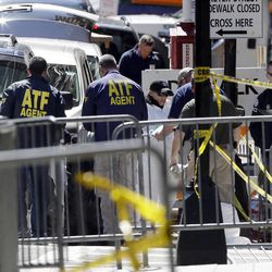 ATF agents and others examine an area of Boylston Street in Boston Thursday, April 18, 2013, as investigation of the Boston Marathon bombings continues. 