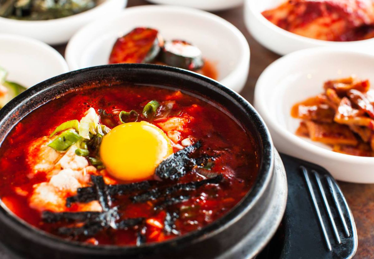 Soondubu jjigae at Korean Tofu House in a pot with sides in the background