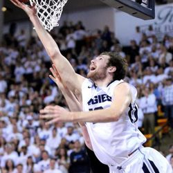 Utah State's David Collette shoots over a Boise State player during an NCAA college basketball game, Tuesday, Feb. 3, 2015, in Logan, Utah. (AP Photo/Herald Journal, John Zsiray)
