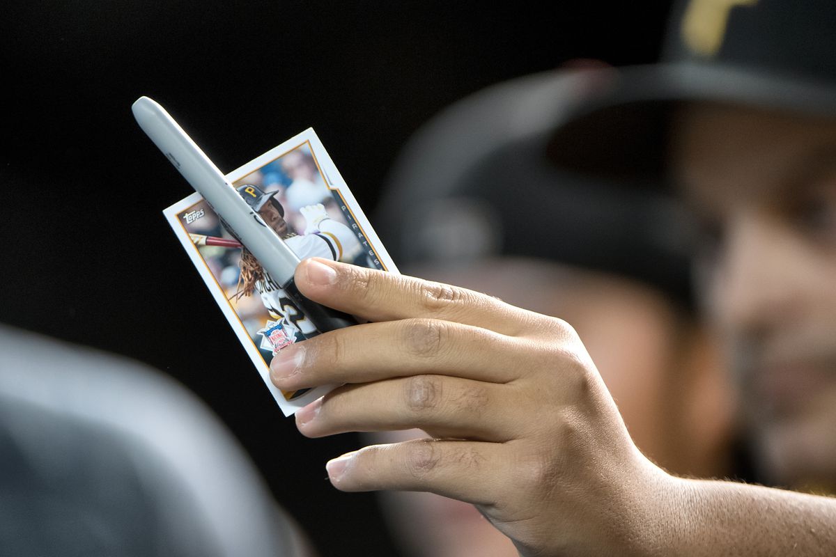 A fan holds up a Pittsburgh Pirates baseball card to be autographed during the MLB baseball game between the Pittsburgh Pirates and the Arizona Diamondbacks on May 13, 2017, at Chase Field in Phoenix, AZ. The Pirates defeated the Diamondbacks 4-3.