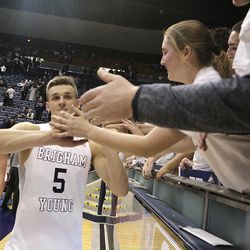 Brigham Young Cougars guard Kyle Collinsworth (5) celebrates with fans after recording his NCAA career record 11th triple-double against Portland at the Marriott Center Thursday, Feb. 25, 2016 in Provo. BYU won 99-81. 