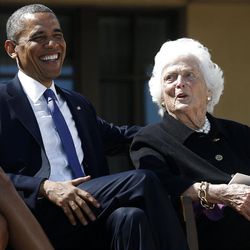 President Barack Obama, left, shares a laugh with former first lady Barbara Bush at the dedication of the George W. Bush presidential library on the campus of Southern Methodist University in Dallas. Former President George W. Bush, above, waves toward guests after the dedication of the library.