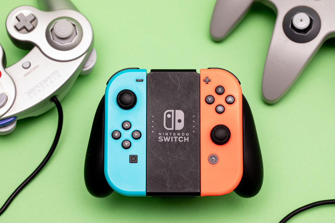 Image of Joy-Cons in a grip on a light green background, surrounded by an N64 and GameCube controller.