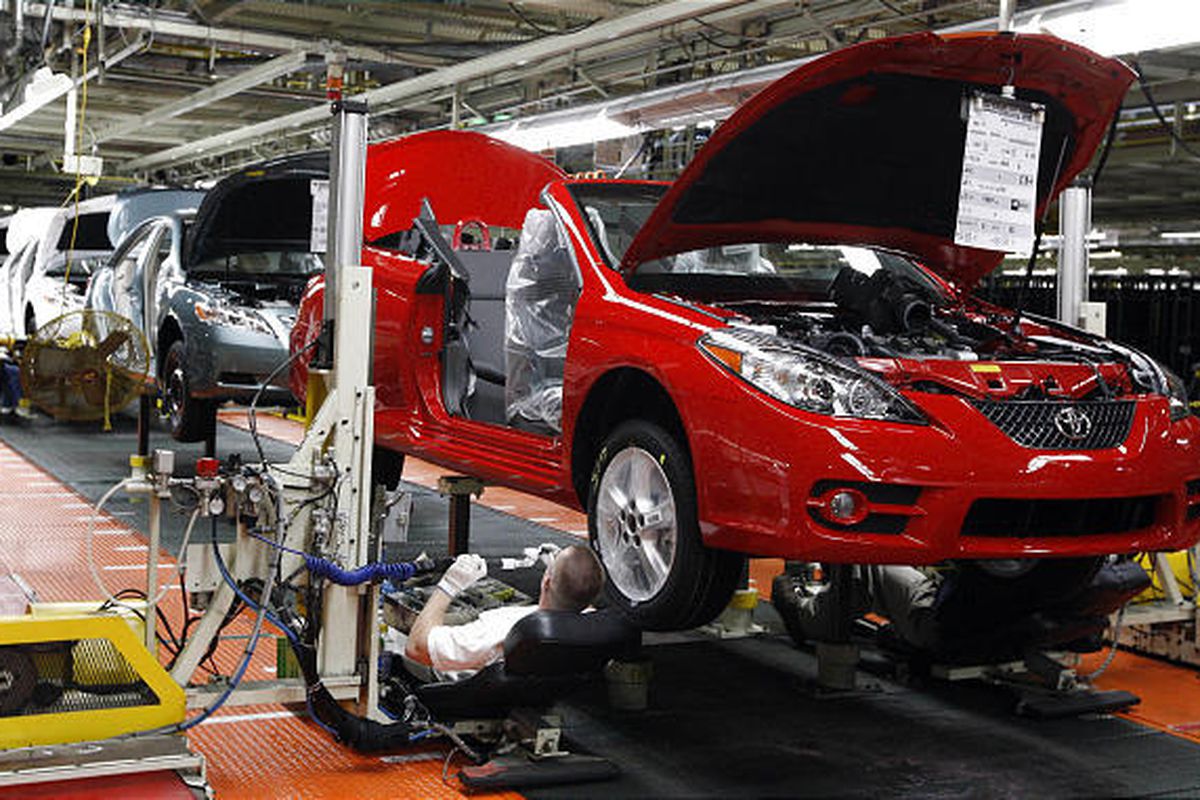 A worker assembles the undercarriage of a Toyota Solara at the Toyota manufacturing plant in Georgetown, Ky.