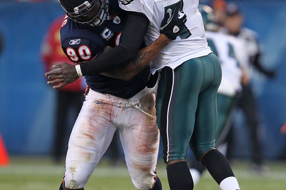 CHICAGO - NOVEMBER 28: Julius Peppers #90 of the Chicago Bears hits Michael Vick #7 of the Philadelphia Eagles at Soldier Field on November 28 2010 in Chicago Illinois. The Bears defeated the Eagles 31-26. (Photo by Jonathan Daniel/Getty Images)
