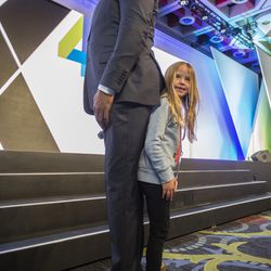 Earvin "Magic" Johnson, retired professional basketball player and president of basketball operations for the L.A. Lakers, and Noa Schreier, of Woodside, California, 6, stand back-to-back to have their picture taken during Qualtrics' X4 Summit at the Salt Palace Convention Center in Salt Lake City on Thursday, March 8, 2018.