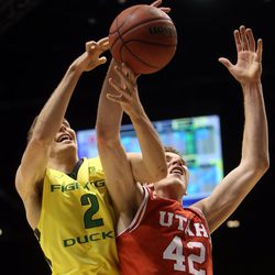 Utah Utes forward Jakob Poeltl (42) gets the ball stripped by Oregon Ducks guard Casey Benson (2) during the first half of the Pac-12 conference tournament championship game at the MGM Grand Garden Arena in Las Vegas, Saturday, March 12, 2016.