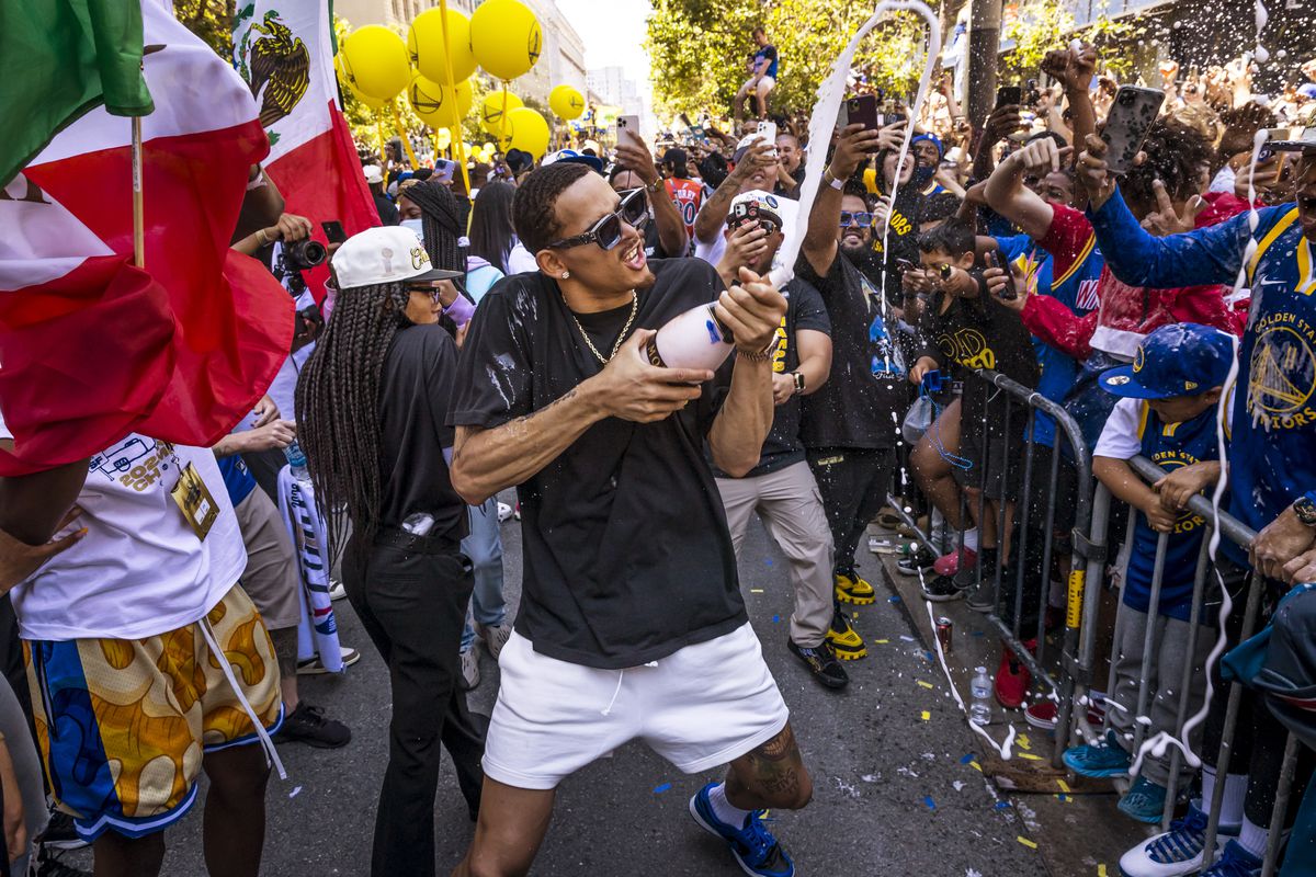 Juan Toscano-Anderson spraying champagne at the Warriors championship parade